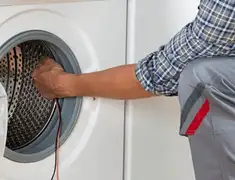 Dryer repair technician diagnosing and servicing a clothes dryer in Shreveport, LA