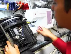 Vacuum repair technician servicing internal components on a workbench in Shreveport, LA
