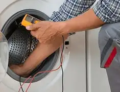 Washing machine repair technician testing a front-load washer with diagnostic tools in Shreveport, LA