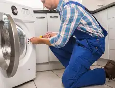 Washing machine repair technician servicing a front-load washer in Shreveport, LA